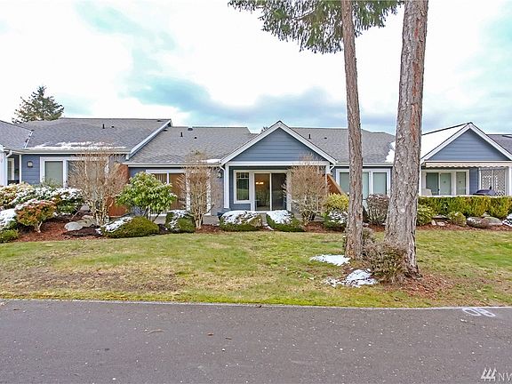Back view of home standing on the golf course
