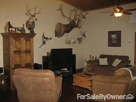 Living room
						:
						Has stained concrete floors. Rustic details include tin ceiling & cedar trim.