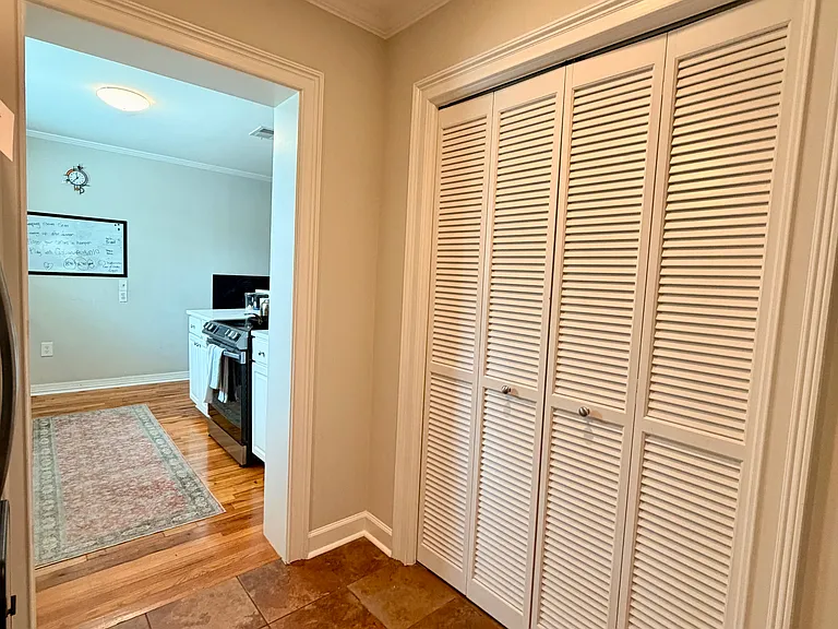 Walkway from kitchen to laundry room, spacious pantry w/ two bifold doors, full fridge/freezer, and coffee nook all included