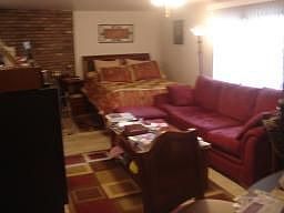 Ground Level Family Room-Fireplace-Tile Floors-Sliders to Patio