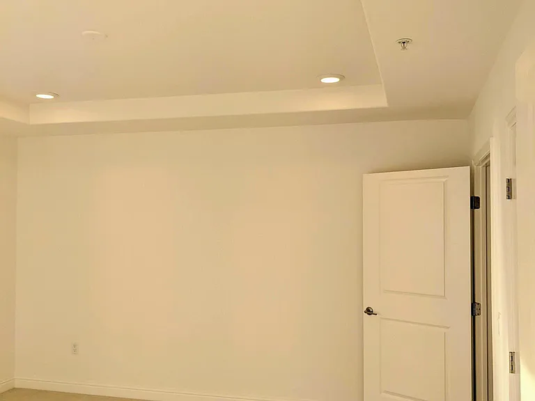 Master bedroom with recessed lighting and contemporary design