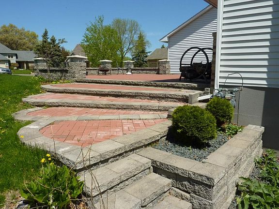 The patio wraps around the home to the backyard
