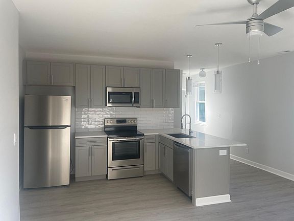 Well-appointed fixtures and ceramic tile backsplash.