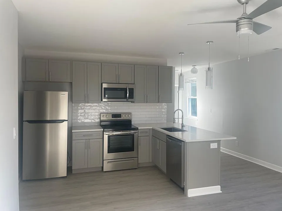 Well-appointed fixtures and ceramic tile backsplash.