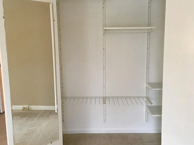 Master bedroom closet with customizable Algol shelves and mi