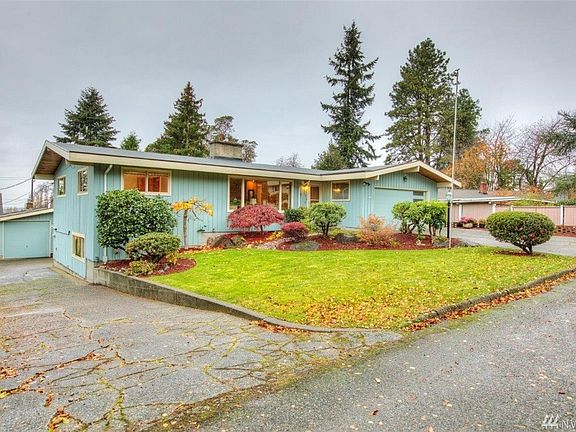 Separate driveway on South side of house to oversize detached garage and shop and backyard
