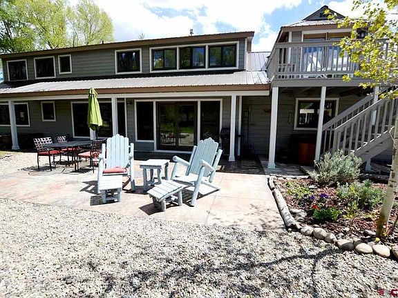 Covered patio for entertaining, hot tub, access to the balcony.