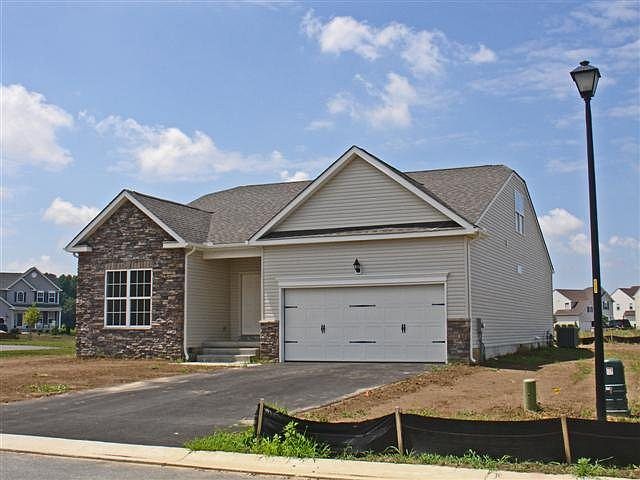 Windsor includes 2 car garage, stone accents, carriage style doors