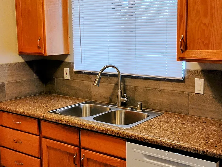 Kitchen with quartz countertops and newer dishwasher