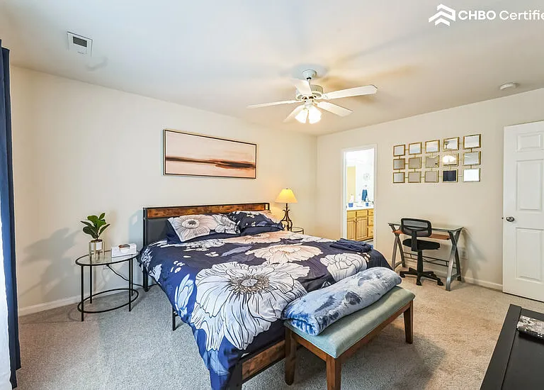 King bed with connected bathroom with tub and shower.
