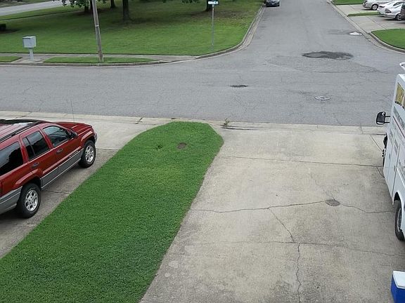 View from master bedroom to front yard and driveway