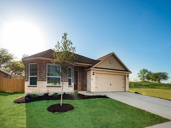 Exquisite home features bay windows over-looking a fully-landscaped front yard.
