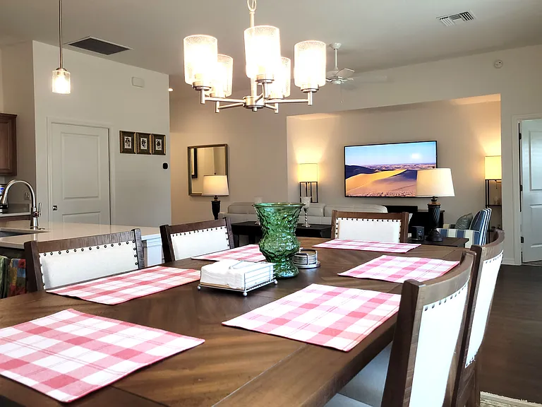 View through the Dining Room Area to the Living Room and Entry to the Master Bedroom.