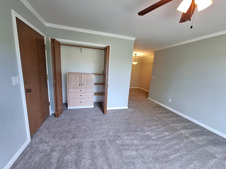 Enter into the living room with large coat closet and built-in organizer.