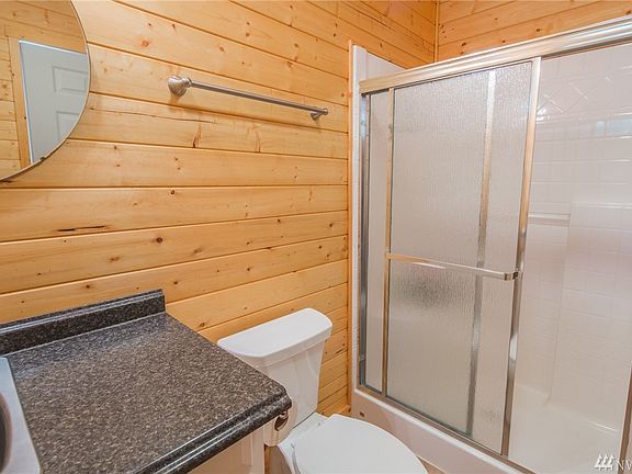 Bath house with sink, toilet & shower. Some additional storage space too.