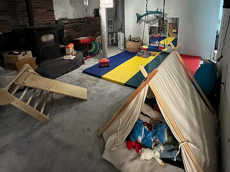 Partially finished basement, shown set up as playroom (previous tenants; will be empty and repainted before move-in). To right are two rooms for storage and a dedicated laundry room with a brand new washer and dryer.