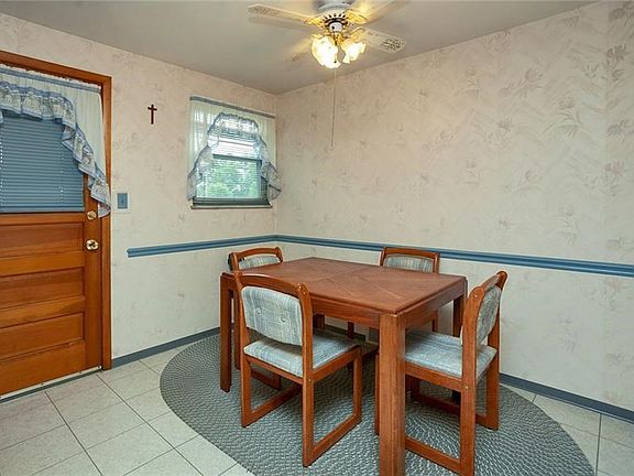 Eat-in kitchen with door that leads to the covered side porch.