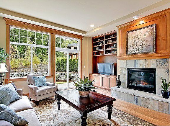 Family room includes hardwood floors, built in entertainment cavinets, gas fireplace with slate tile