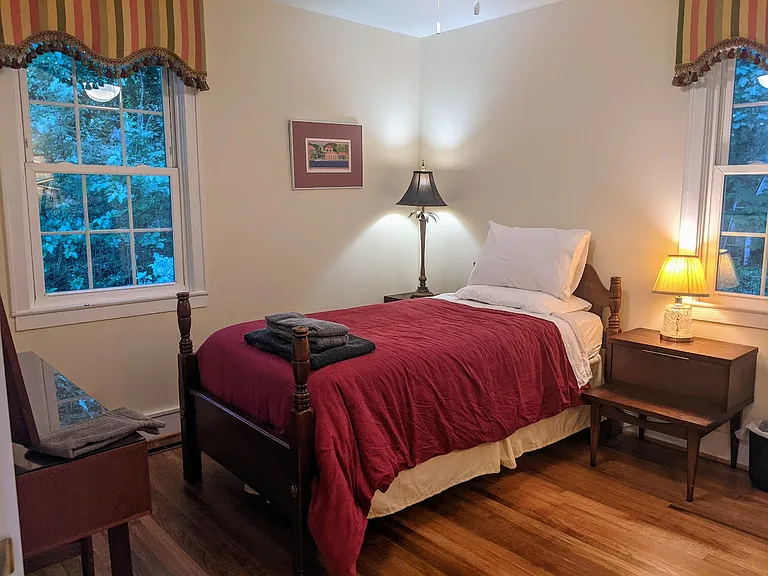 Second bedroom with single bed, desk, dresser and two night stands.