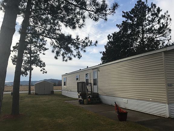 Large yard with vinyl shed
