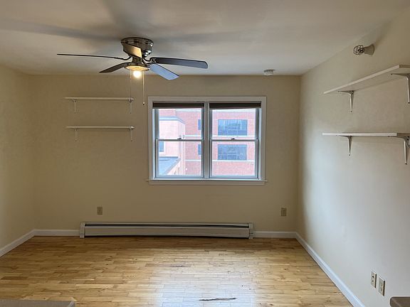 Living room with closet and shelving.