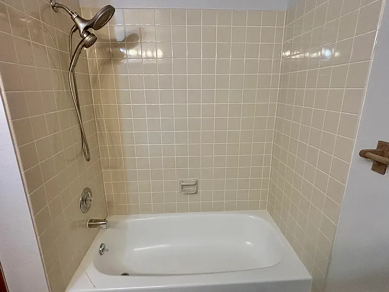 Upstairs shower with a tub.