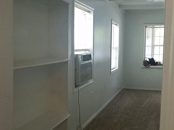 View of built-in bookshelf and view of living room