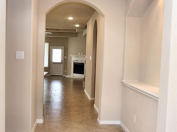 Entry way with tile flooring and art niches