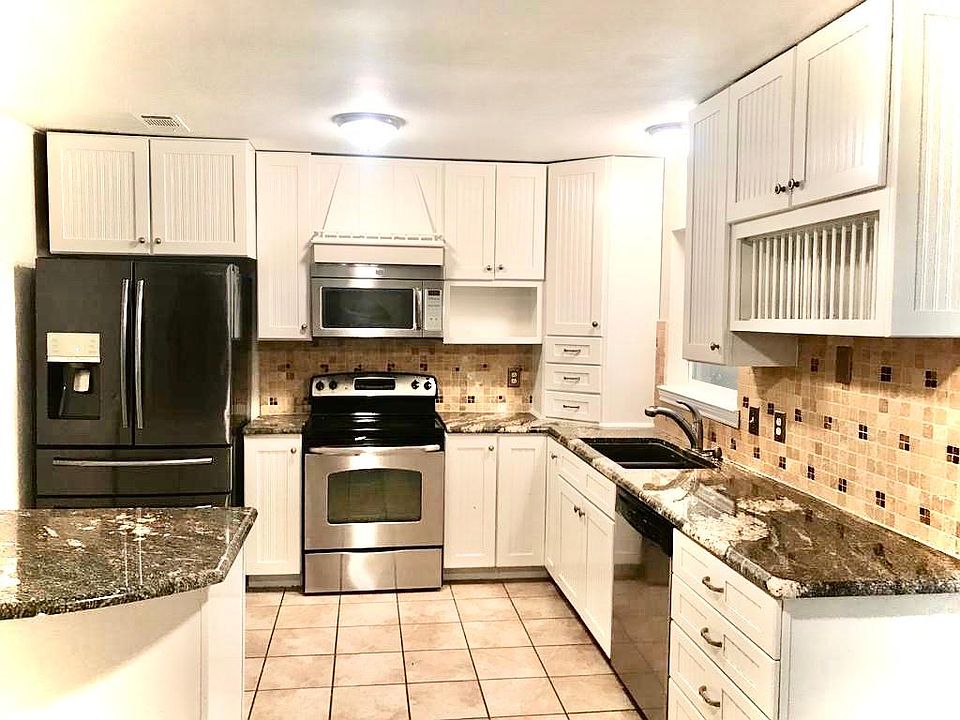 Kitchen with remodeled cabinets, countertop and fixtures.