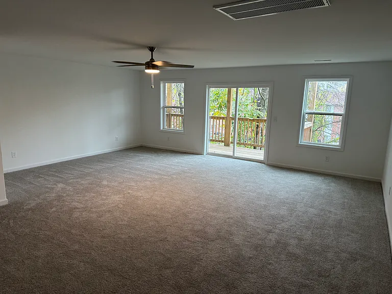 Basement living and/or recreation area with glass sliding doors.