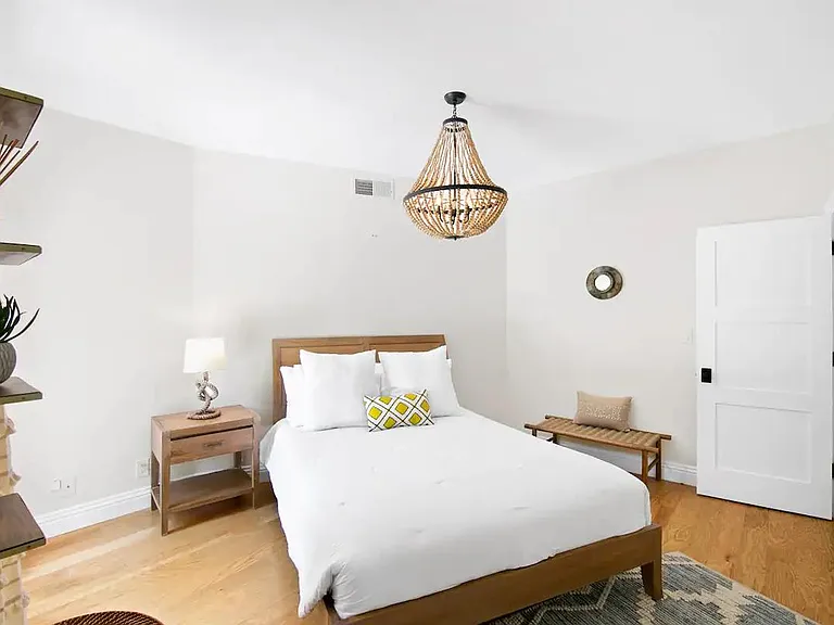 Guest bedroom with a queen sized bed lined with plush and clean sheets, ready for you to fall into.