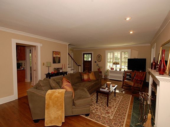 Formal LR w/ woodburning fireplace & built-in cabinetry