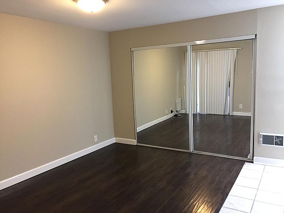 Bedroom and closet with wood floors.