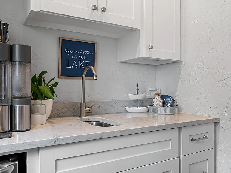 Kitchenette with coffee pot and small sink.