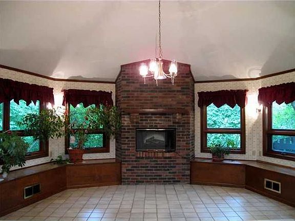 Hearth Room: Overlooks wooded backyard. Features Fireplace & Built-in Storage.