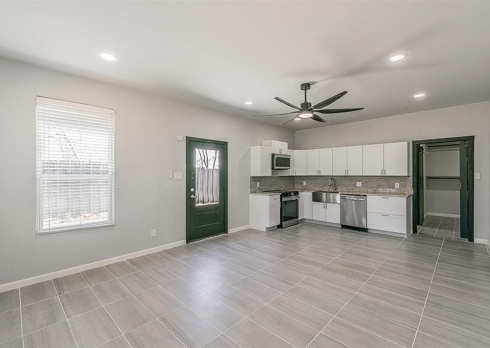 Kitchen featuring a ceiling fan, white cabinetry, tasteful backsplash, stainless steel appliances, and recessed lighting