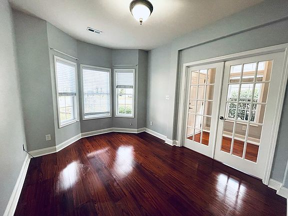 Office with bay windows and French doors