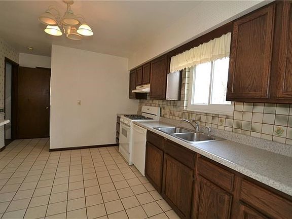 Kitchen approximately 12 x 11 with ceramic tile, back splash and updated counter tops