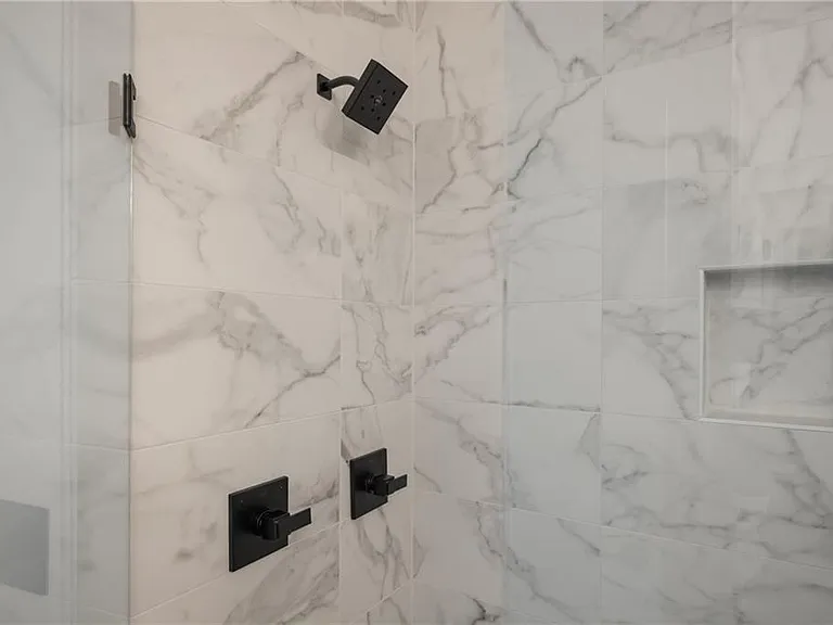 Main Bathroom (Note: Actual unit has light wooden floors and upgraded fixtures / appliances)