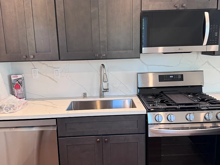 kitchen with dishwasher, gas range and deep sink