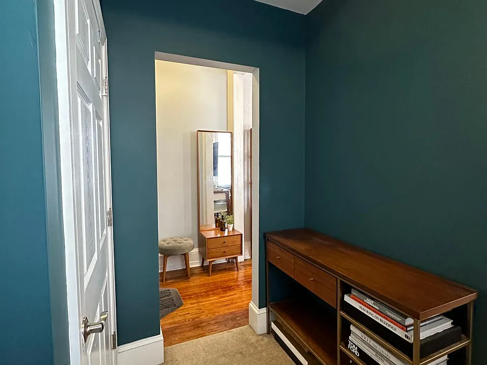 Breezeway with coat closet, leads to the living room and 2nd floor.