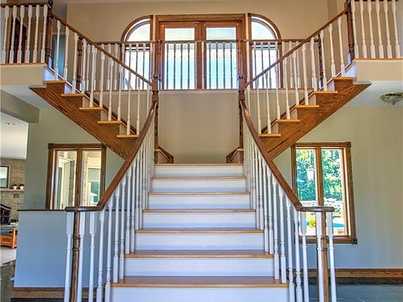 Imperial Staircase in the Foyer leads to the Upper Level Balcony, 3 Generous Size Bedrooms and 2 Full Baths.