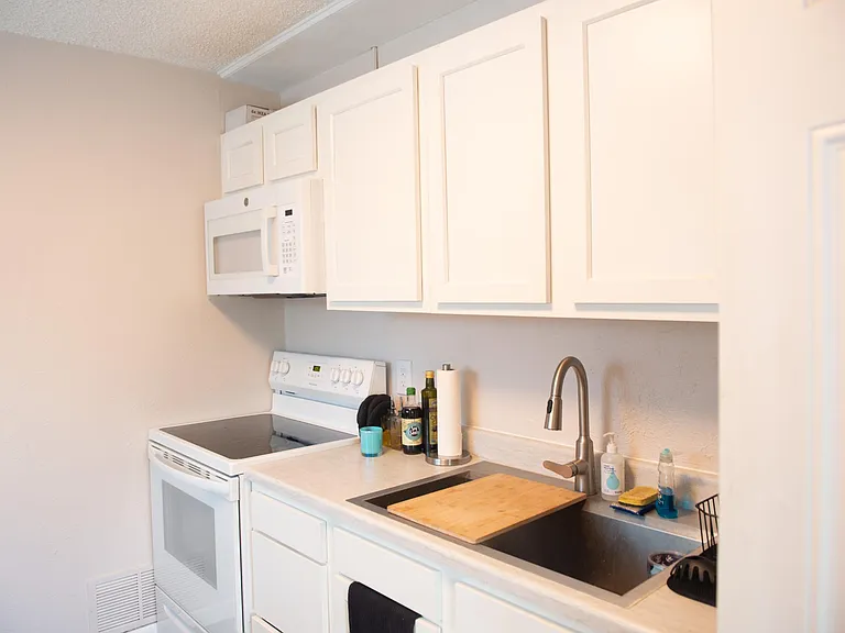 new kitchen with glass top stove, oversized sink and dishwasher