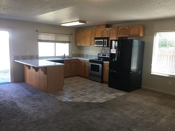 Large kitchen with electric stove, microwave and dishwasher. Great breakfast bar countertop. Refrigerator included for tenant use at no additional charge.