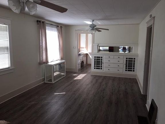 Living room facing towards kitchen back of house and hallway