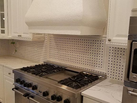 Six burner stove with griddle and two ovens.