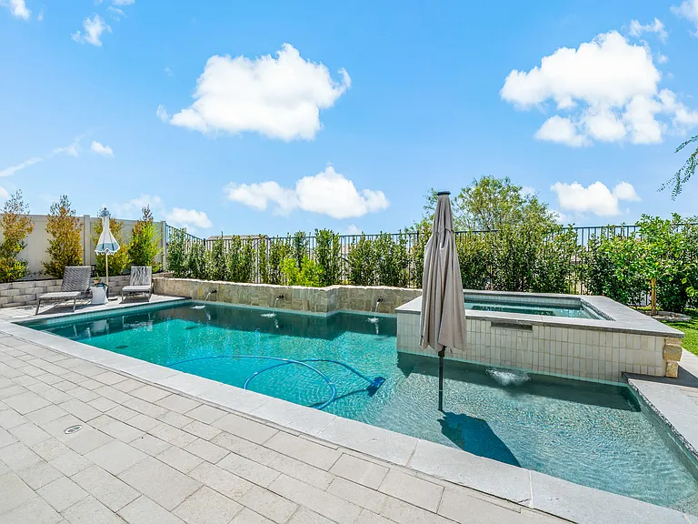 Pool offers a baja shelf with privacy hedge around the perimeter