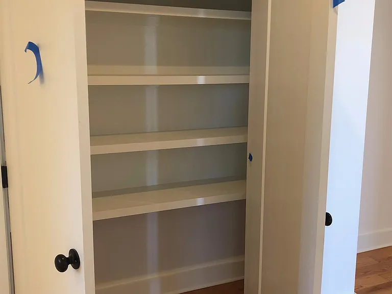 Hall double door linen closet nestled next to guest full bath and across from laundry room.