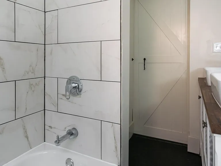 Tile surround in shower, new fixtures, sliding barn door