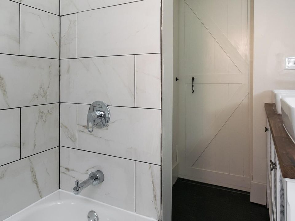Tile surround in shower, new fixtures, sliding barn door
